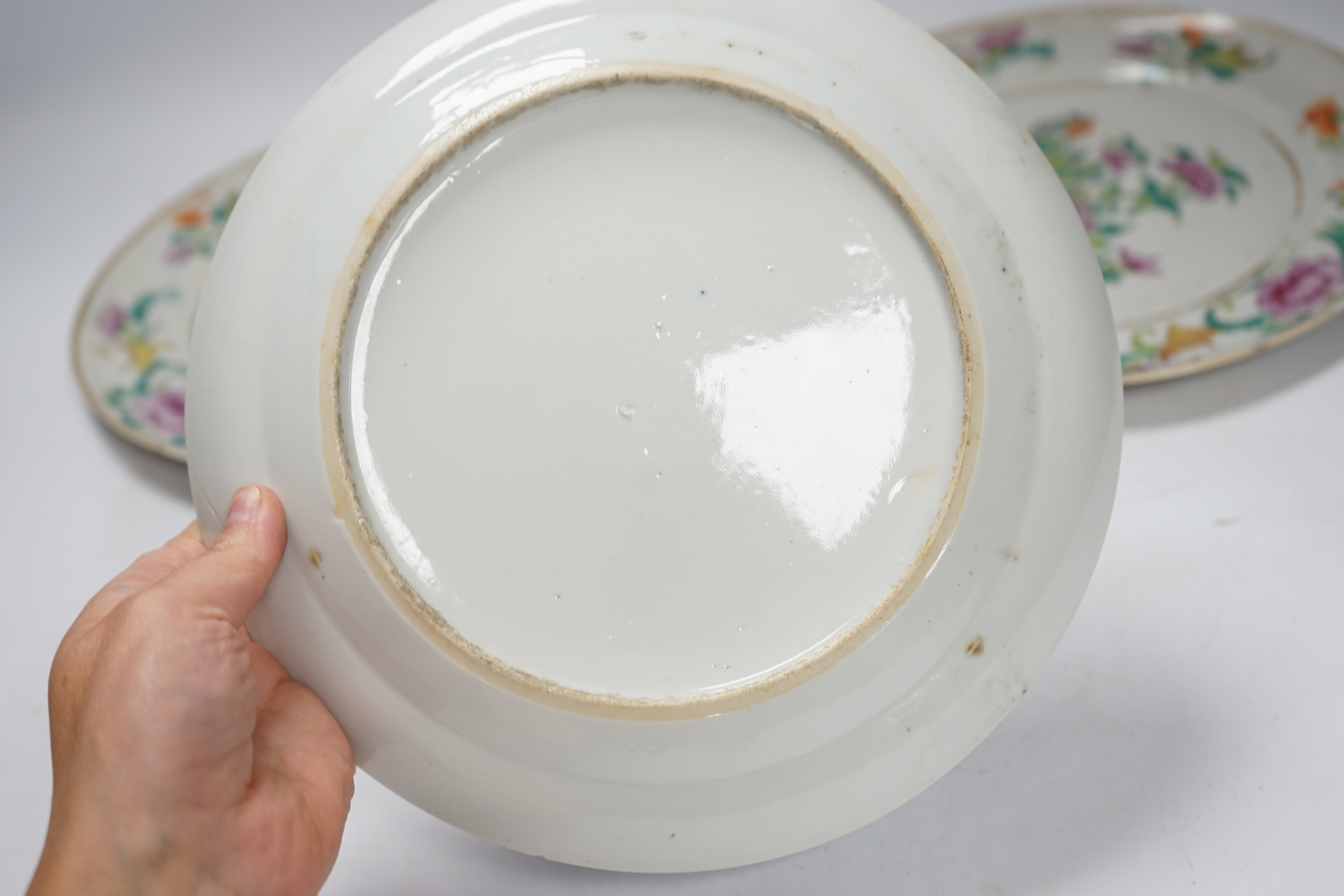 A pair of 19th century Chinese famille rose plates and another blue and white, largest 25cm diameter. Condition - blue and white good, others poor to fair